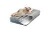 A woman sleeping on an inflatable mattress with a cutaway view showing the internal structure. Podgląd zdjęcia produktu