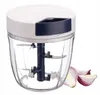 A manual food chopper with red onion slices next to it. Produktbild-Vorschau