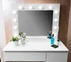 A white vanity table with a mirror and various cosmetic products. Produktbild-Vorschau