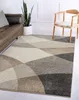 A living room scene with a sofa, plant, chair, and a rug. Produktbild-Vorschau
