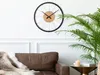 A modern living room with a brown leather sofa, a plant, and a large wall clock. Produktbild-Vorschau