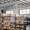 A warehouse interior with shelves stacked with cardboard boxes. Produktbild-Vorschau