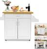 A white kitchen cart with a wooden top, decorated with a vase of flowers, a bowl of fruit, a slice of cake, a glass of wine, and a bottle of wine.