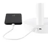 A black smartphone is plugged into a white charging cable which is connected to a white device, likely a lamp or fan base. Anteprima dell’immagine prodotto