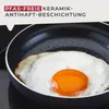 A fried egg is cooking in a small frying pan. Produktbild-Vorschau