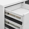 Close-up view of the inside of a white filing cabinet with open drawers and metal drawer slides. Anteprima dell’immagine prodotto