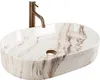 A white oval countertop sink with a marble-like pattern and a bronze faucet. Náhľad obrázku produktu
