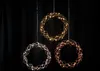 Three decorative LED wreaths are hanging against a black background. Produktbild-Vorschau