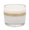 A product shot of a cream jar with a gold band and clear lid. Produktbild-Vorschau