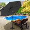 A dark gray patio umbrella is set up next to a lounge chair by a swimming pool. Voir les images du produit