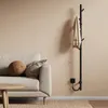 A modern living room with a sofa, coffee table, and a wall-mounted electric towel warmer. Produktbild-Vorschau
