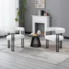 Two white armchair chairs with black metal legs are arranged around a small black coffee table in a living room setting. Produktbild-Vorschau