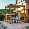 A family is enjoying a meal under a pergola in their backyard. Náhled obrázku produktu
