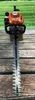 A Stihl hedge trimmer is displayed on a wooden surface with a blurred green background. Produktbild-Vorschau