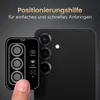 A hand is shown holding a camera lens protector template next to a smartphone camera. Produktbild-Vorschau