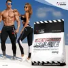 A man and a woman posing in athletic wear next to a bag of protein powder. Produktbild-Vorschau