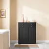A black bathroom cabinet with two drawers and two doors is shown in a bathroom setting. Podgląd zdjęcia produktu