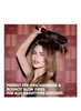 A woman is using a hair dryer brush on her hair. Produktbild-Vorschau