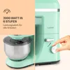 A split image showing a close-up of a mint green kitchen mixer on the left, and a person's hand adjusting the speed dial of a similar mixer on the right, with marketing text on the left side. Produktbild-Vorschau