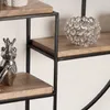 A close-up view of a decorative wall shelf with a silver frog figurine and a crystal candle holder. Voir les images du produit