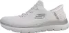A side view of a white Skechers slip-on shoe with silver accents. Voir les images du produit
