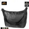 A black Helikon-Tex Carryall Backup Bag is shown against a white background. Several small color swatches are visible at the bottom. Produktbild-Vorschau