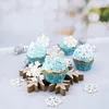 Winter-themed cupcakes decorated with snowflakes and silver balls, arranged on a snowflake-shaped stand. Anteprima dell’immagine prodotto