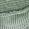 A close-up of a textured, ribbed fabric, likely corduroy, in an olive green color. The fabric is folded, showing the texture and the edge of a seam or hem. Náhľad obrázku produktu