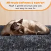 A Siamese cat is resting on a plush, dark gray surface, with text overlay describing the product's softness and comfort. Produktbild-Vorschau