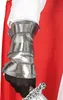 Close-up of a person's arm wearing a silver gauntlet over a white sleeve, with a red cape in the background and a sword hilt visible. Produktbild-Vorschau
