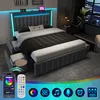 A modern bedroom with a grey upholstered bed featuring LED lighting and storage drawers, shown with a smartphone app and remote control. Produktbild-Vorschau