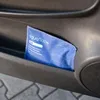 A blue moisture absorber bag is placed in a car door pocket. Anteprima dell’immagine prodotto