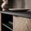 A close-up view of a modern TV cabinet with a wooden front and a black countertop. Produktbild-Vorschau