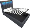 A bed frame with the mattress support raised to show the storage compartment underneath. The headboard has built-in lighting. Produktbild-Vorschau