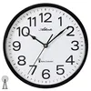 A close-up studio shot of a white analog wall clock with a black frame, displaying the time. Produktbild-Vorschau