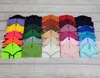 A collection of folded fabric items, likely horse accessories, arranged in rows on a wooden surface. Náhľad obrázku produktu