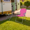 A pink camping chair and small table are set up on the grass next to an open camper van. Produktbild-Vorschau