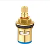 A close-up studio shot of a brass faucet valve cartridge against a white background. Produktbild-Vorschau
