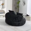 A black bean bag chair with pillows in a modern living room setting. Podgląd zdjęcia produktu