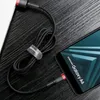A black braided USB-C cable is connected to a Samsung Galaxy A6 smartphone, with the cable neatly coiled and secured with a strap. The scene is set on a dark, textured surface. Náhľad obrázku produktu