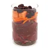 A glass container filled with layers of raw meat, shredded carrots, diced fruit, and dried berries. Produktbild-Vorschau