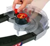 A close-up shot of a toy car track set with a hand operating a mechanism. Produktbild-Vorschau