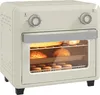 A cream-colored retro-style air fryer oven with bread and pastries inside. Produktbild-Vorschau