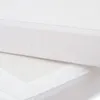 A close-up view of two white mattress covers, one slightly overlapping the other. Produktbild-Vorschau