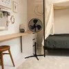 A bedroom with a desk, fan, and bed. Voir les images du produit