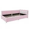 A pink sofa bed with a white scalloped headboard and a pink bow detail. Náhled obrázku produktu