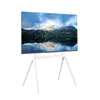 A television on a white stand, displaying a landscape image. Produktbild-Vorschau
