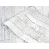 A roll of wood-effect wallpaper is partially unrolled, showing a distressed white wood plank design. Produktbild-Vorschau