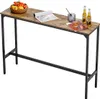 A long, narrow bar table with a wood-look top and black metal legs, set against a white background. There are some decorative items on the table. Podgląd zdjęcia produktu