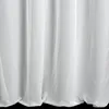 A close-up view of white fabric, likely a curtain, with soft folds and shadows. Produktbild-Vorschau